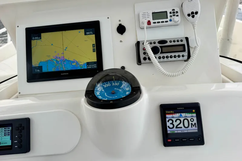 Slide: The Image of Dashboard of a 2007 Intrepid 327 Cuddy boat with navigation and communication equipment. - 18