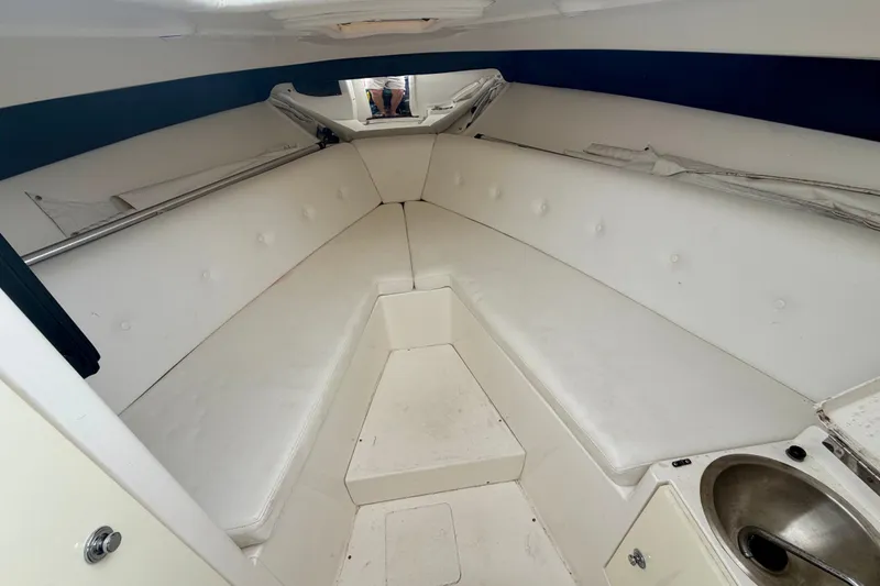 Slide: The Image of 2007 Intrepid 327 Cuddy cabin interior with white seating and compact sink. - 13