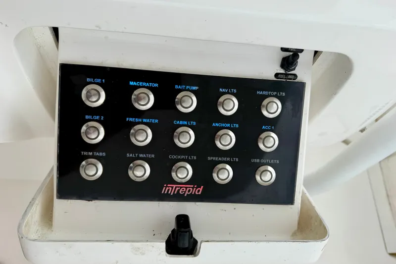 Slide: The Image of Control panel of a 2007 Intrepid 327 Cuddy boat with labeled buttons. - 17