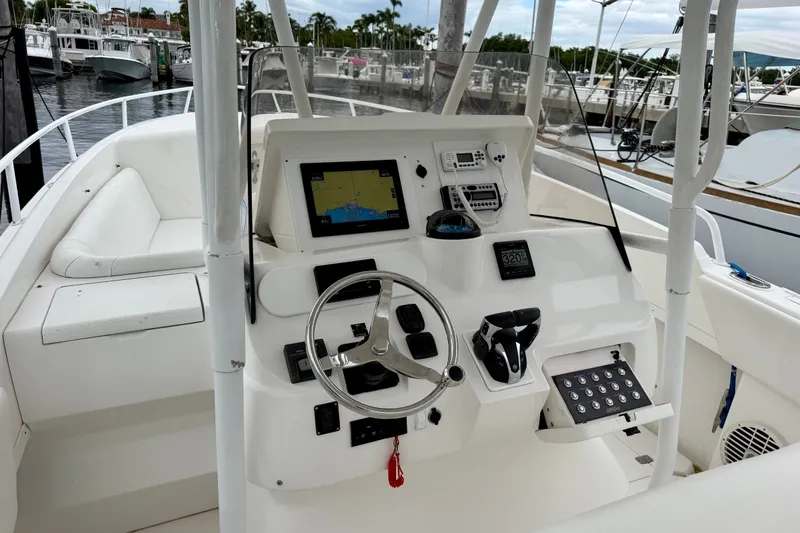 Slide: The Image of 2007 Intrepid 327 Cuddy boat cockpit with steering wheel and navigation equipment. - 7