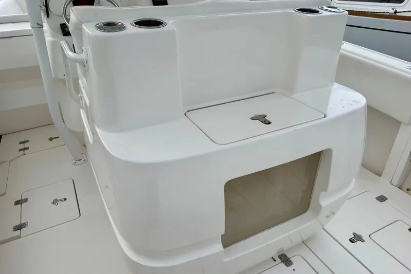 Slide: The Image of 2007 Intrepid 327 Cuddy boat interior with storage compartments and cup holders. - 12