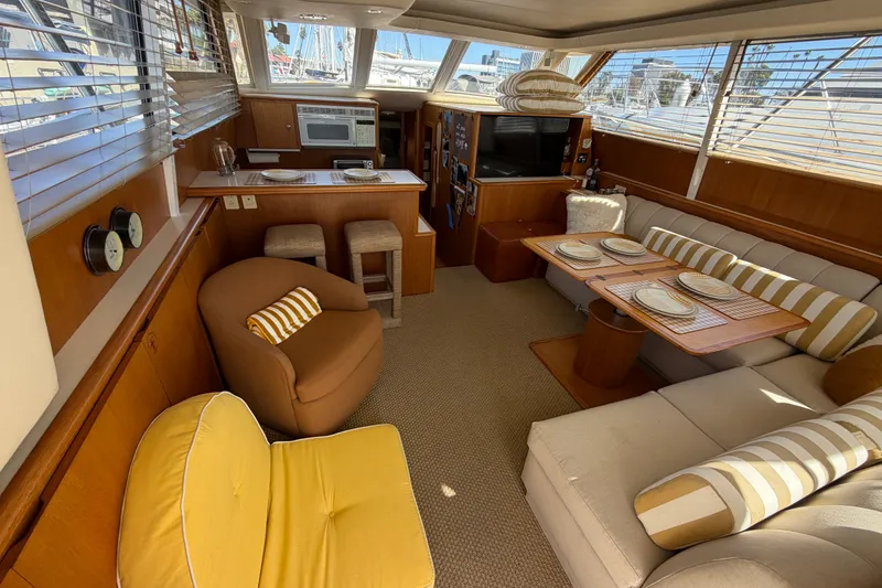 Slide: The Image of Luxurious interior of 2000 Tiara Yachts 4300 Convertible with cozy seating and dining area. - 34