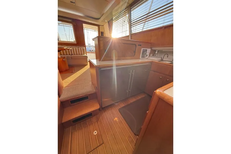 Slide: The Image of Interior of 2000 Tiara Yachts 4300 Convertible with kitchen and seating area. - 26