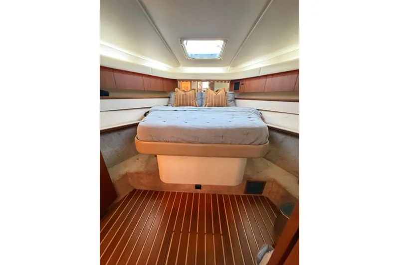 Slide: The Image of Interior cabin of 2000 Tiara Yachts 4300 Convertible with bed and wooden flooring. - 14