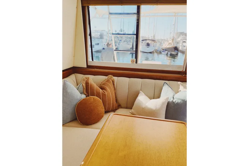 Slide: The Image of Cozy interior of 2000 Tiara Yachts 4300 Convertible with marina view through window. - 10