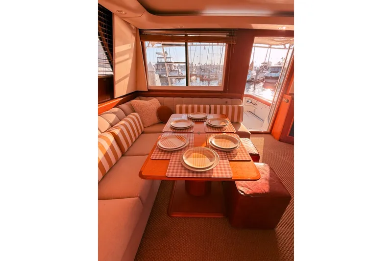 Slide: The Image of Luxurious dining area inside a 2000 Tiara Yachts 4300 Convertible, featuring elegant table settings. - 21