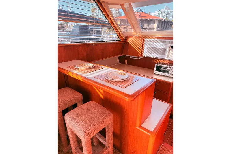 Slide: The Image of Interior of 2000 Tiara Yachts 4300 Convertible with wooden dining area and modern appliances. - 25