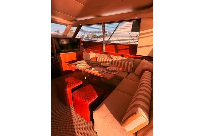 Slide: The Image of Luxurious interior of 2000 Tiara Yachts 4300 Convertible with elegant dining setup. - 22