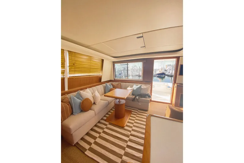 Slide: The Image of Luxurious interior of 2000 Tiara Yachts 4300 Convertible with cozy seating and striped rug. - 12