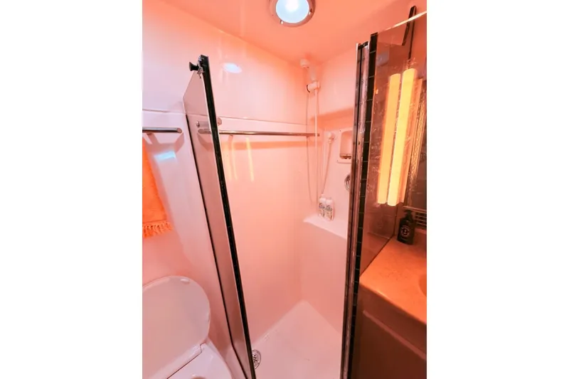 Slide: The Image of Bathroom interior of 2000 Tiara Yachts 4300 Convertible, featuring shower and modern lighting. - 15
