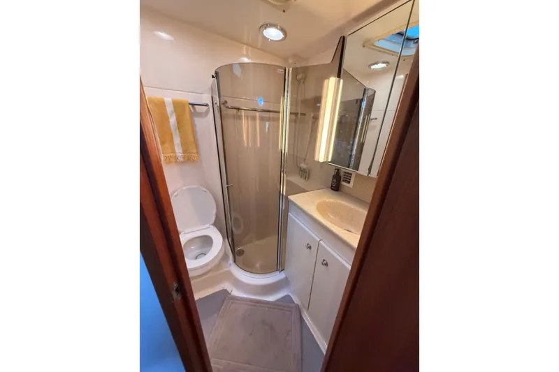Slide: The Image of Bathroom interior of 2000 Tiara Yachts 4300 Convertible with shower and vanity. - 13