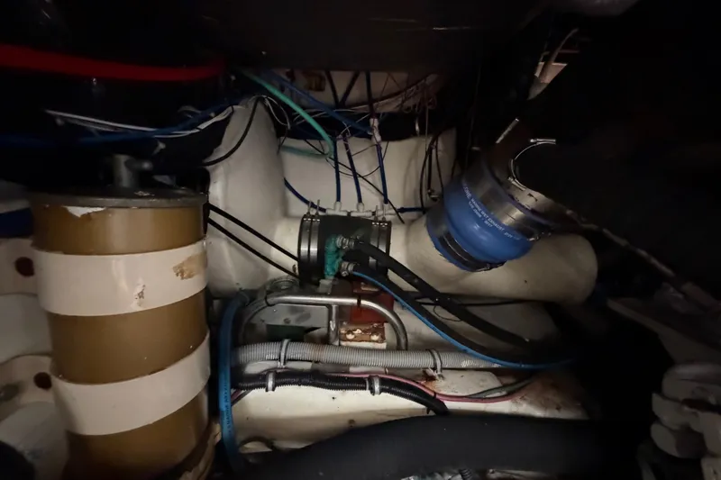 Slide: The Image of Engine room of a 2000 Tiara Yachts 4300 Convertible, showcasing mechanical components and wiring. - 37