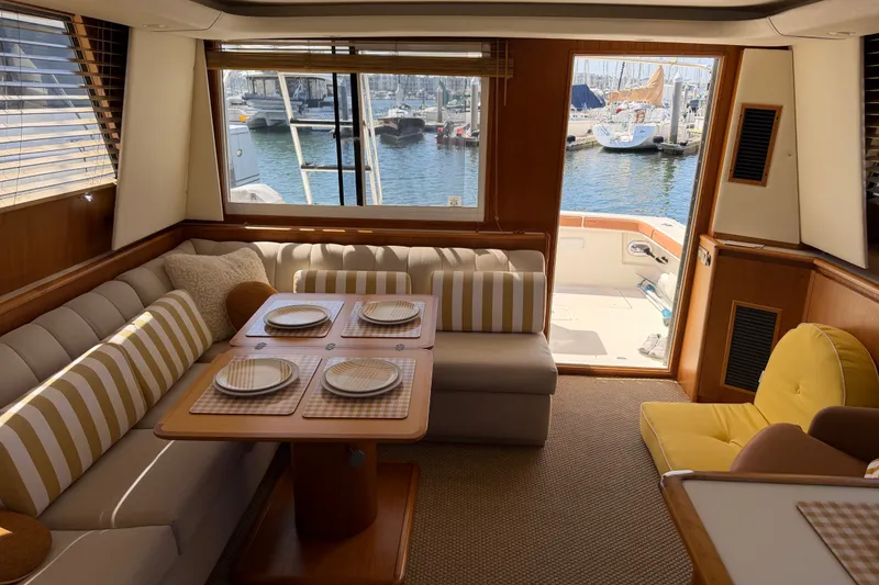 Slide: The Image of Luxurious interior of 2000 Tiara Yachts 4300 Convertible with elegant dining area and marina view. - 28