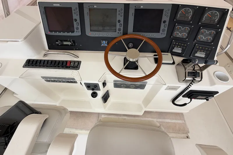 Slide: The Image of Cockpit of 2000 Tiara Yachts 4300 Convertible with steering wheel and navigation instruments. - 7