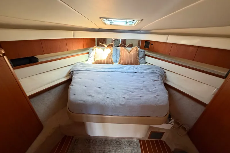 Slide: The Image of Luxurious bedroom interior of 2000 Tiara Yachts 4300 Convertible with cozy bedding. - 35
