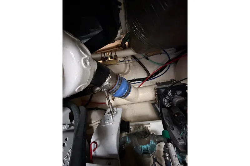 Slide: The Image of Engine room of 2000 Tiara Yachts 4300 Convertible, showcasing mechanical components and wiring. - 38