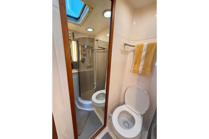 Slide: The Image of Bathroom interior of 2000 Tiara Yachts 4300 Convertible, featuring shower and toilet. - 23
