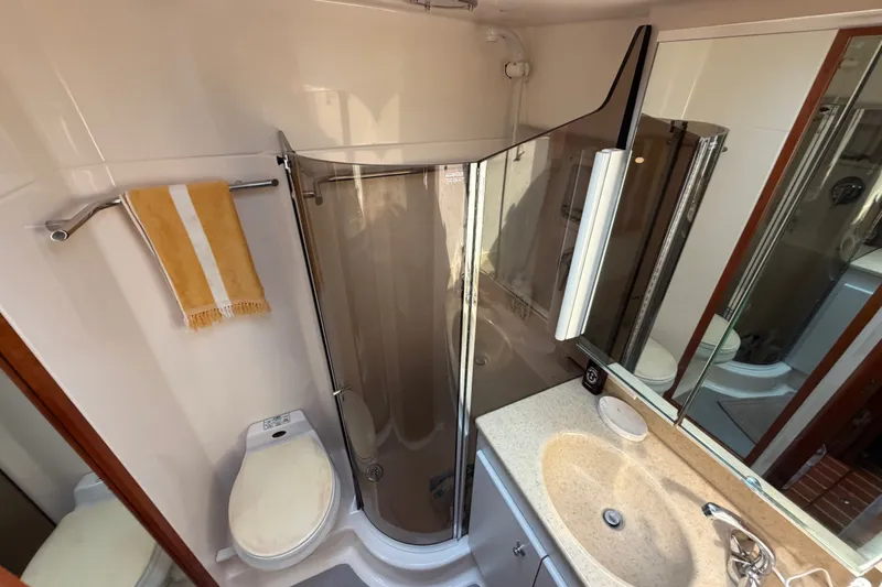 Slide: The Image of Bathroom interior of 2000 Tiara Yachts 4300 Convertible with shower, sink, and toilet. - 30
