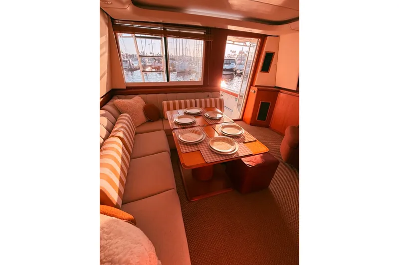 Slide: The Image of Luxurious interior of 2000 Tiara Yachts 4300 Convertible with elegant dining setup. - 20