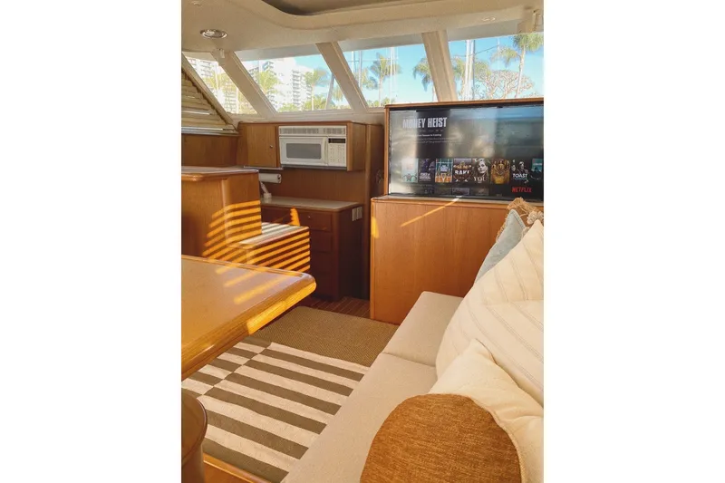 Slide: The Image of Interior of 2000 Tiara Yachts 4300 Convertible with cozy seating and entertainment system. - 11