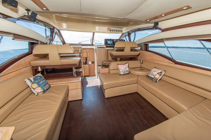 Slide: The Image of Interior of a 2008 Azimut 47 with elegant leather sofas and large windows offering sea views. - 18