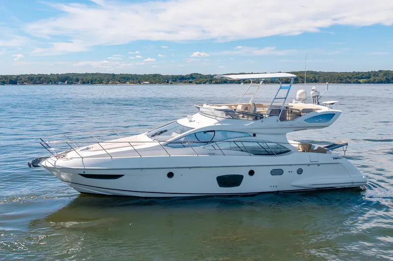 Slide: The Image of A sleek 2008 Azimut 47 yacht on calm waters with a clear sky in the background. - 7