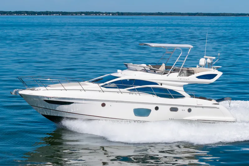 Slide: The Image of A sleek 2008 Azimut 47 yacht cruising swiftly across the water. - 43