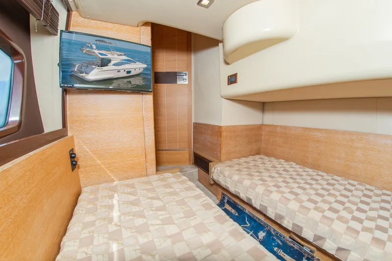 Slide: The Image of Interior of a 2008 Azimut 47 with two single beds and a window. - 33