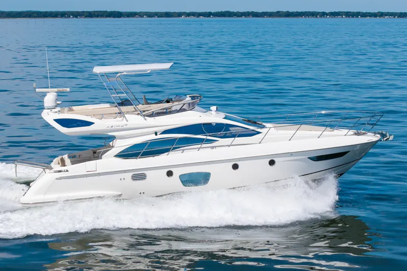 Slide: The Image of A sleek 2008 Azimut 47 yacht speeds across the water, with a clear sky in the background. - 4