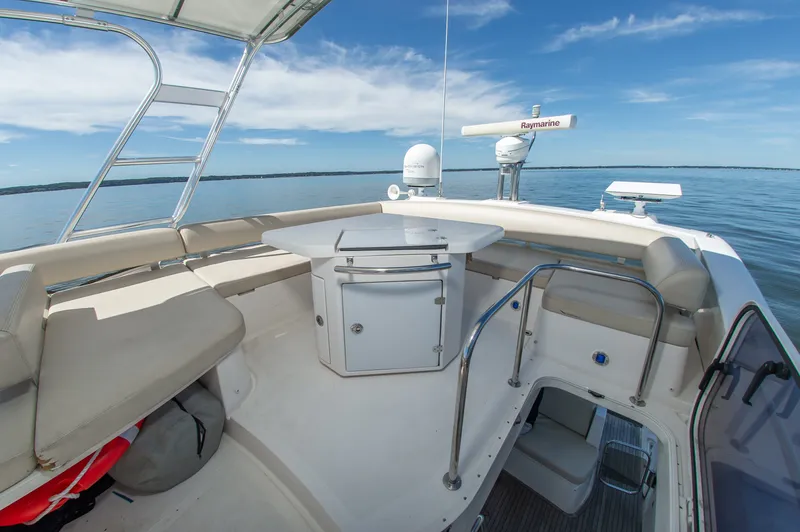 Slide: The Image of The image shows the deck of a 2008 Azimut 47 with seating and a table. - 14