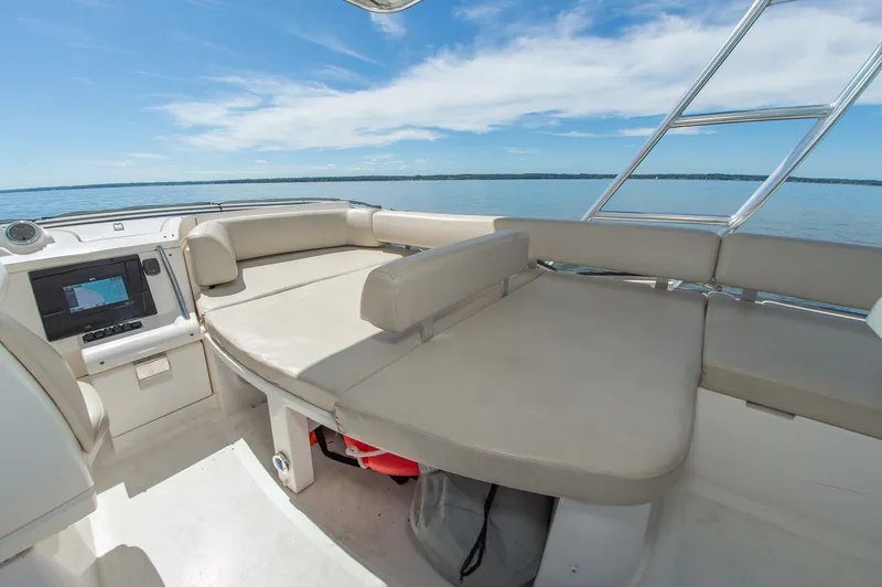 Slide: The Image of The image shows the deck of a 2008 Azimut 47 with beige cushioned seating and a helm station. - 15