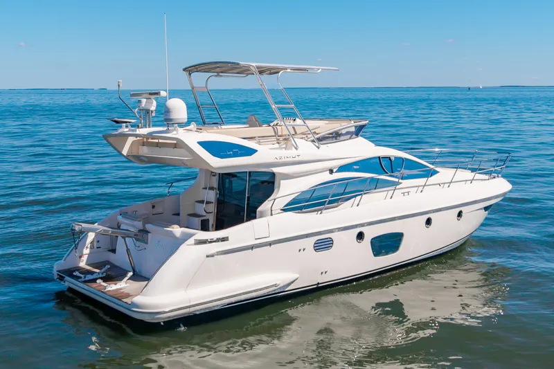 Slide: The Image of A sleek 2008 Azimut 47 yacht on calm waters, featuring a spacious deck and modern design. - 5