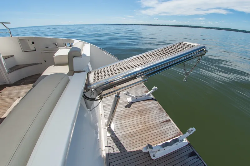 Slide: The Image of The 2008 Azimut 47 features an elegant swim platform with wooden decking and stainless steel railing. - 12