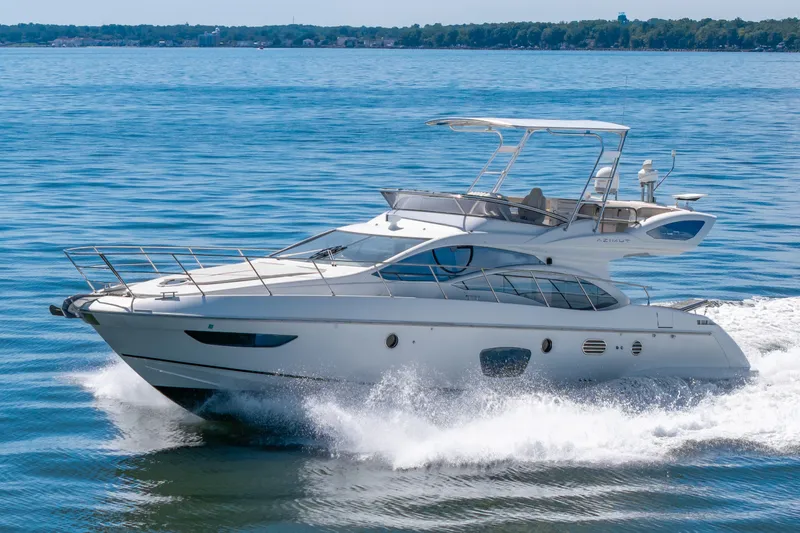 Slide: The Image of A sleek 2008 Azimut 47 yacht cruising swiftly on the water. - 42