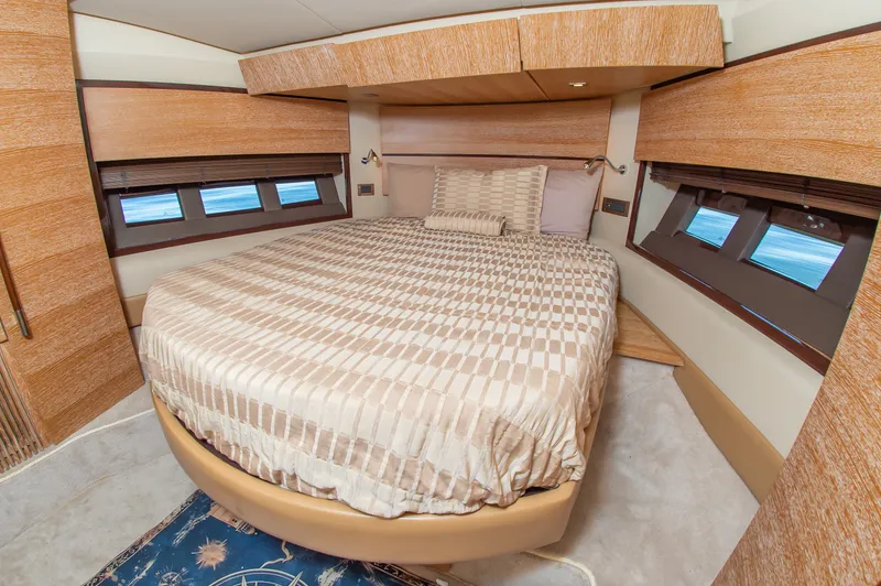 Slide: The Image of Luxurious bedroom with a large bed and wooden walls in a 2008 Azimut 47 yacht. - 25