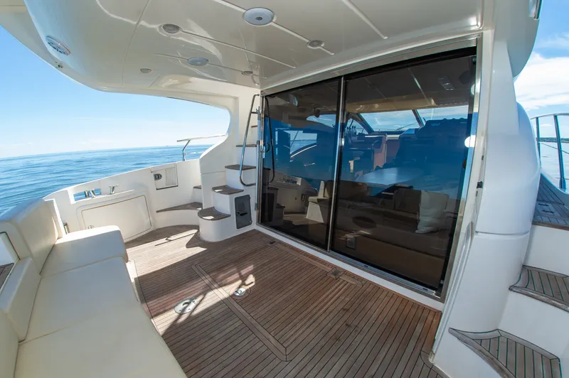 Slide: The Image of The 2008 Azimut 47 features an elegant deck with wooden flooring and comfortable seating. - 9