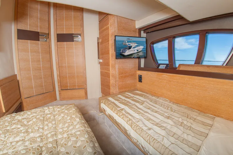 Slide: The Image of Interior of a 2008 Azimut 47 with two beds and a window overlooking the sea. - 31