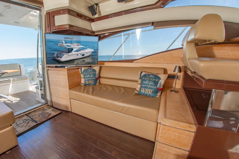 Slide: The Image of Interior of a 2008 Azimut 47 with leather sofa, cushions, and TV. Light wood decor. - 19
