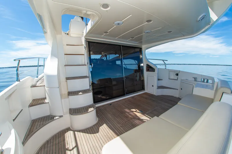 Slide: The Image of The 2008 Azimut 47 features a spacious aft deck with elegant seating and a staircase. - 8
