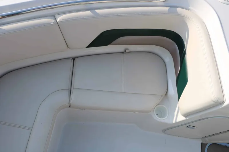 Slide: The Image of The image shows white upholstery in the bow area of a boat with green accents. - 20