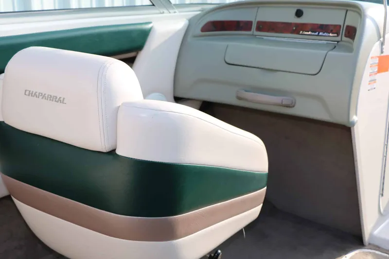 Slide: The Image of The image shows the interior of a 1997 Chaparral 2130 Sport Limited with green and white seating. - 30