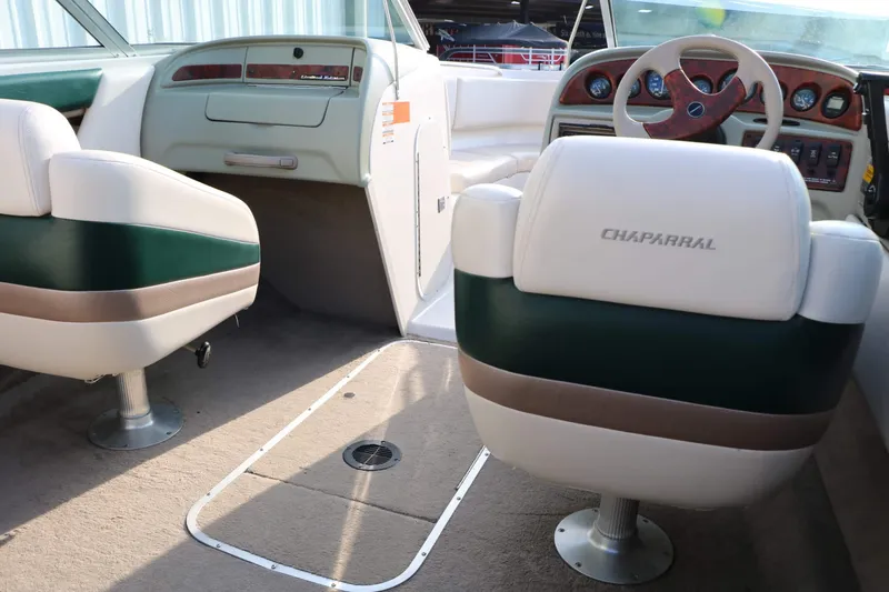 Slide: The Image of The image shows the cockpit of a 1997 Chaparral 2130 Sport Limited with two upholstered seats. - 31