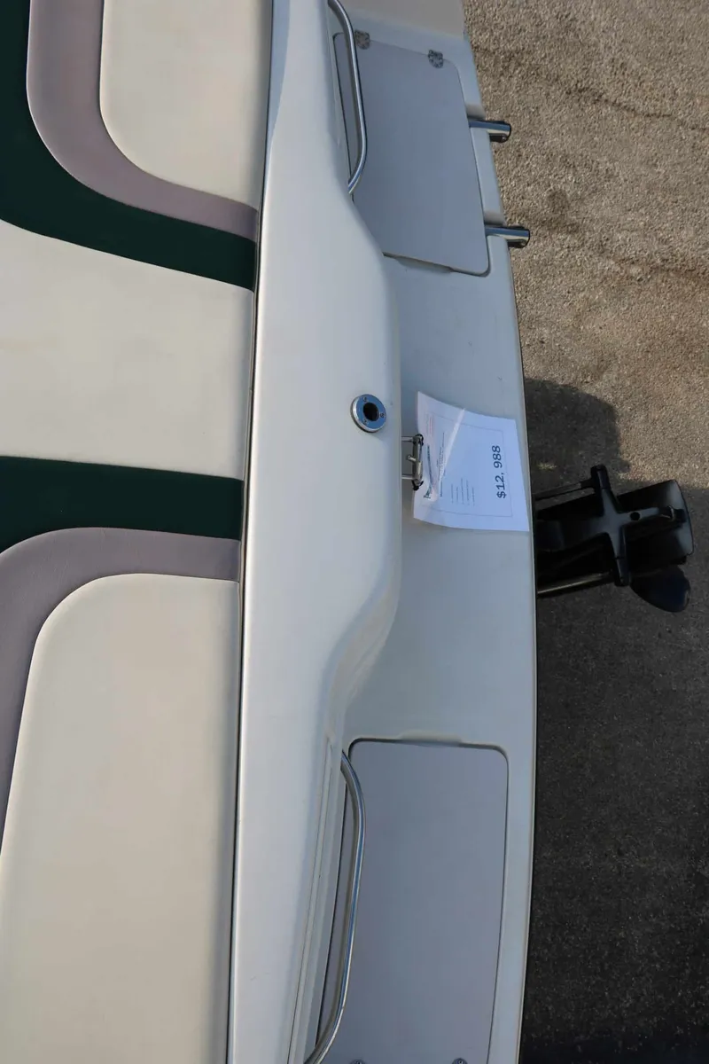 Slide: The Image of The image shows the stern of a 1997 Chaparral 2130 Sport Limited boat with an outboard motor. - 34