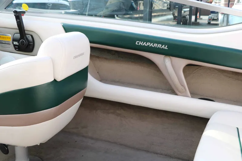 Slide: The Image of The image shows the cockpit of a 1997 Chaparral 2130 Sport Limited with green and white seating. - 33