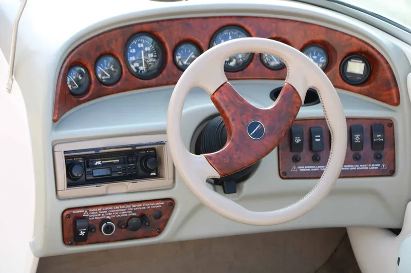Slide: The Image of The image shows the dashboard of a 1997 Chaparral 2130 Sport Limited with wood trim and steering wheel. - 13