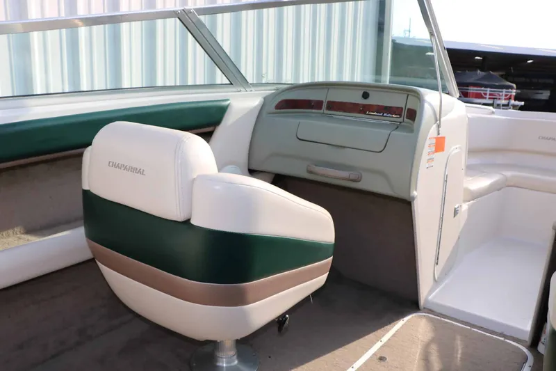 Slide: The Image of The image shows the cockpit of a 1997 Chaparral 2130 Sport Limited with a green and white seat. - 29