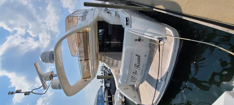 Slide: The Image of A luxurious white yacht docked, featuring a spacious flybridge deck. - 7