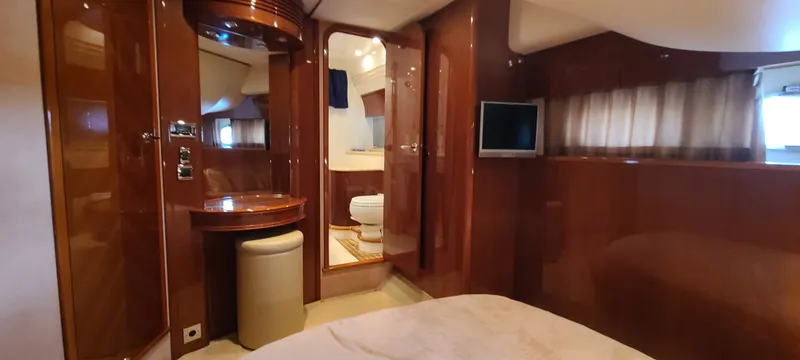 Slide: The Image of Luxurious cabin with glossy wood walls, a small table with stool, and a television. - 24