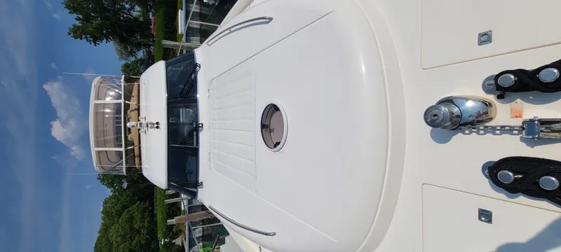 Slide: The Image of The 2006 Viking Princess 61 Flybridge features a sleek deck design with anchor chain and polished anchor. - 8