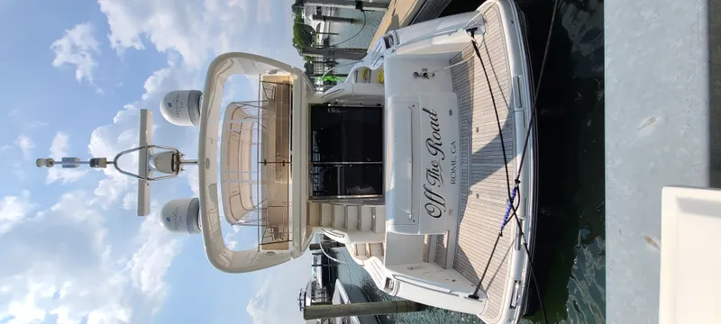 Slide: The Image of A luxurious yacht with a flybridge, docked, featuring an elegant white structure and modern amenities. - 6